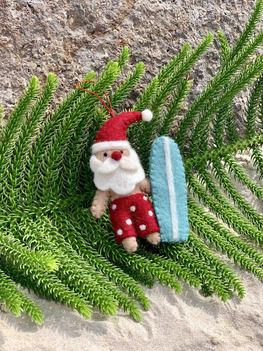 Pashom Santa with red shorts & blue surfboard